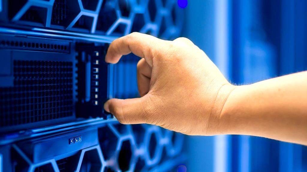 Technician configuring servers in a server rack